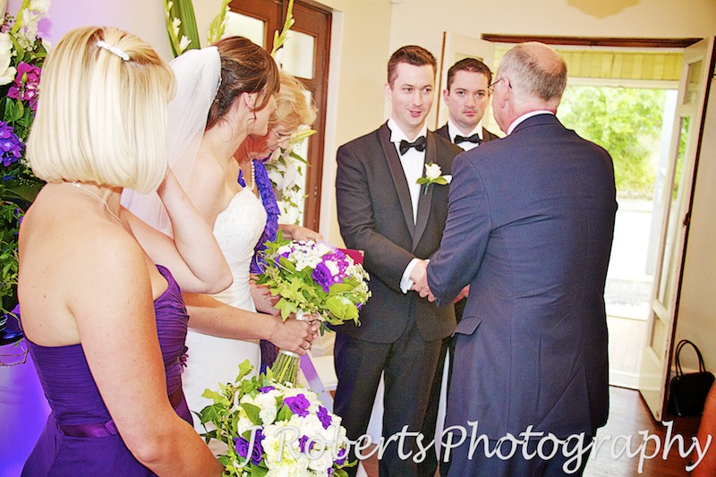 brides father shakes hand of groom and bridesmaid cries - wedding photography sydney